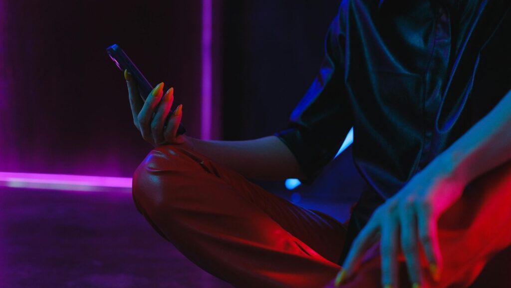 Woman using smartphone on studio floor